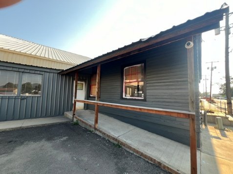 Restored clapboard on the office, front of building painted