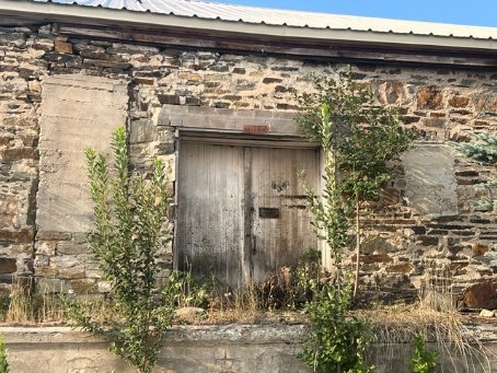 Rear barn door and concrete-covered window bays