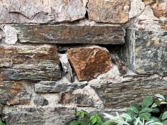 Holes, cracks, and deterioration along the stonewall