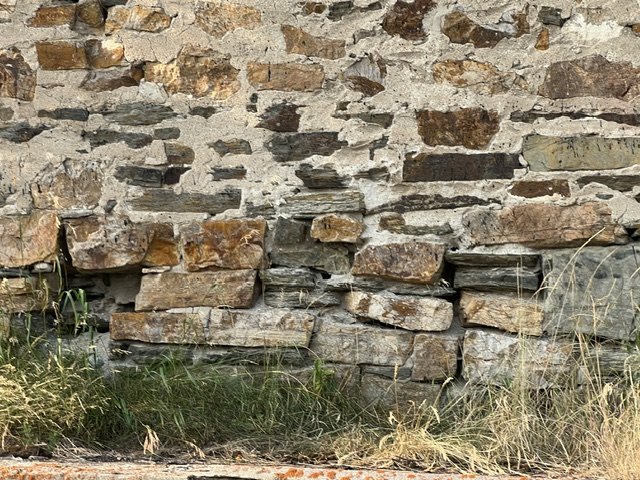 Holes, cracks, and deterioration along the stonewall